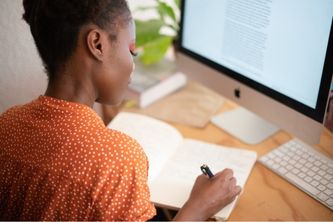 Lady writing at computer